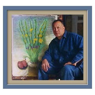Man sitting beside floral painting in frame.