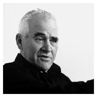Elderly man in black and white portrait.