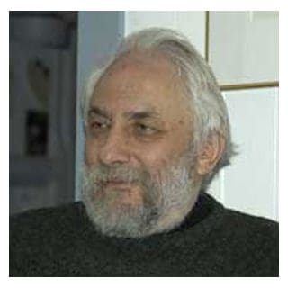 Elderly man with gray beard and hair.