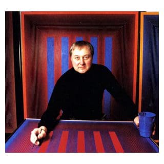Man in front of colorful striped artwork.