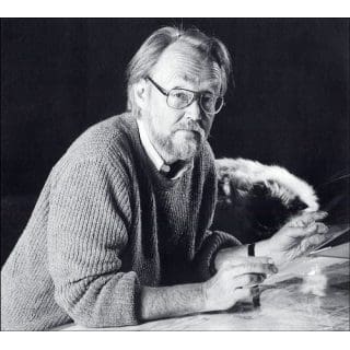 Man sitting at a desk with pen.