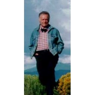 Man in denim jacket, outdoor background.