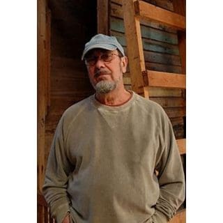 Man in casual clothing, wearing a cap.