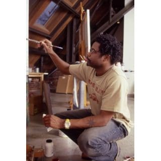 Artist painting in a studio setting.