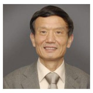 Smiling man in a suit and tie.
