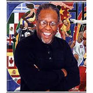Smiling man with glasses in front of mural