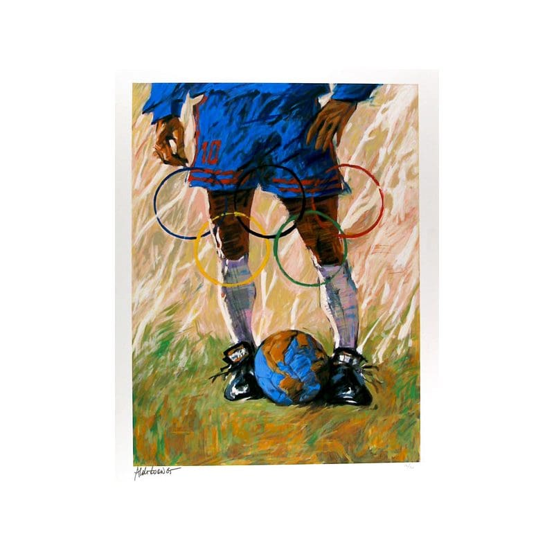 Child ready to kick a soccer ball on grass.